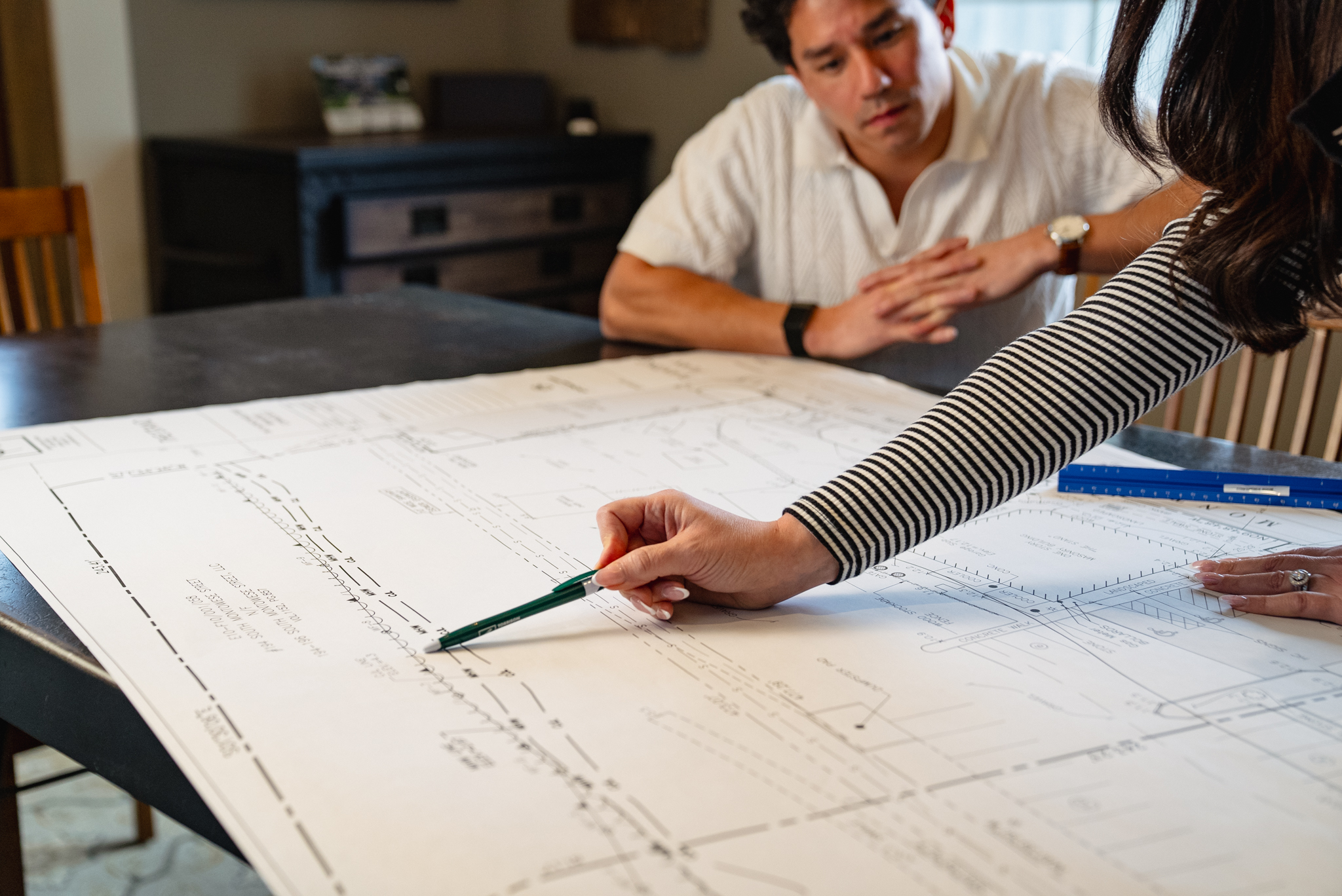 Detailed landscape architecture plan with labeled pool, patio zones, outdoor seating areas, walkways, and planting beds for a residential property